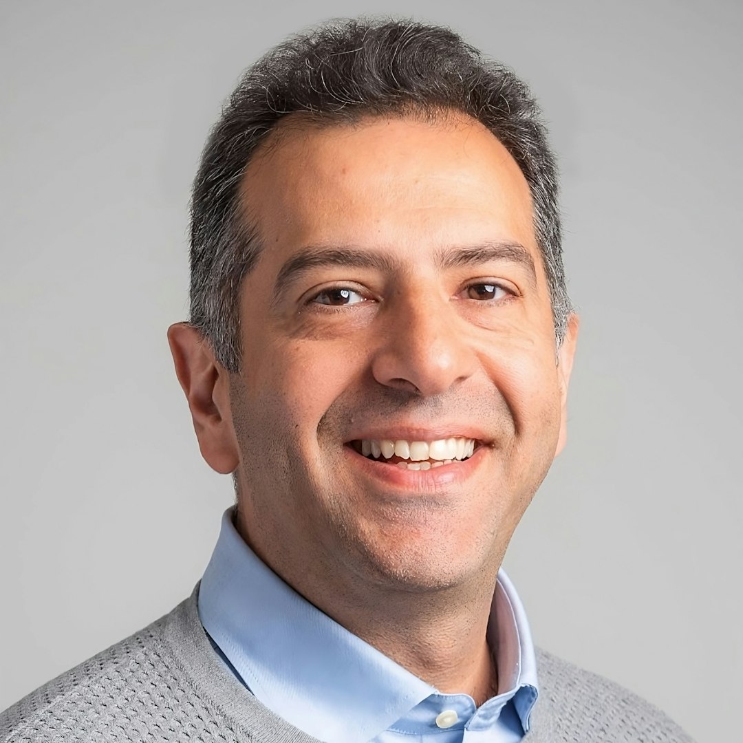 Smiling man looks at the camera for a portrait.